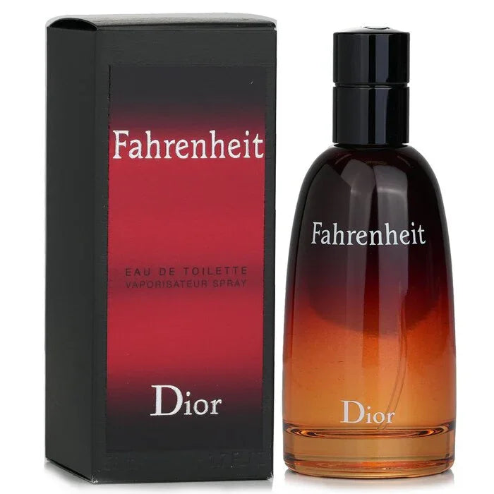 A slender glass bottle of Dior Fahrenheit Eau de Toilette with its iconic red-to-black gradient, standing next to its textured black rectangular gift box featuring a matching red-and-black gradient panel and white branding.